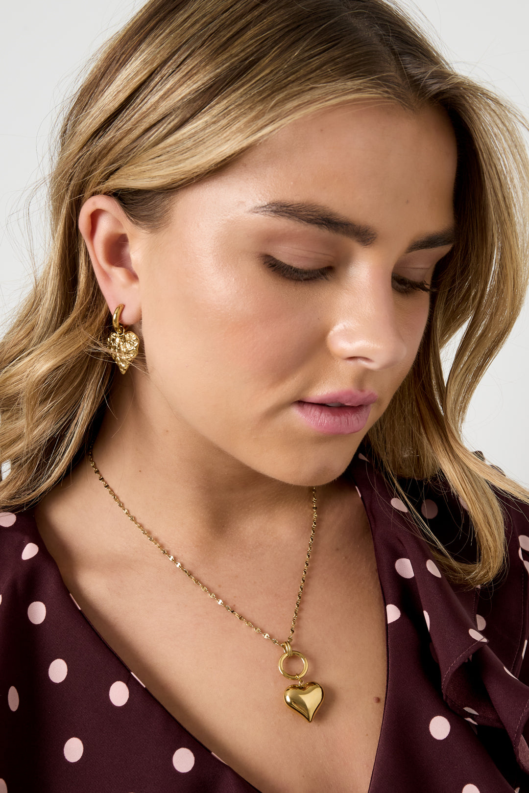 Gold Love necklace featuring a simple heart pendant worn around the neck from Sorea Fashion.