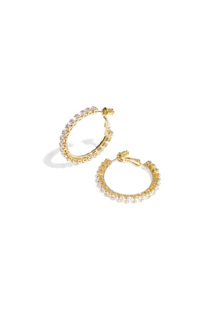 Gold hoop earrings displayed as a pair on a white background, Rina earrings by Sorea Fashion.