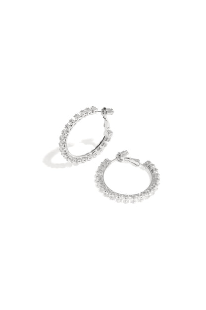 Minimalist silver hoop earrings displayed on a white background, Rina earrings from Sorea Fashion.