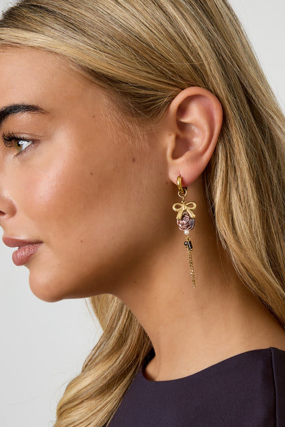 Gold Rosey earrings featuring textured rose-shaped elements worn in the ear from Sorea Fashion.