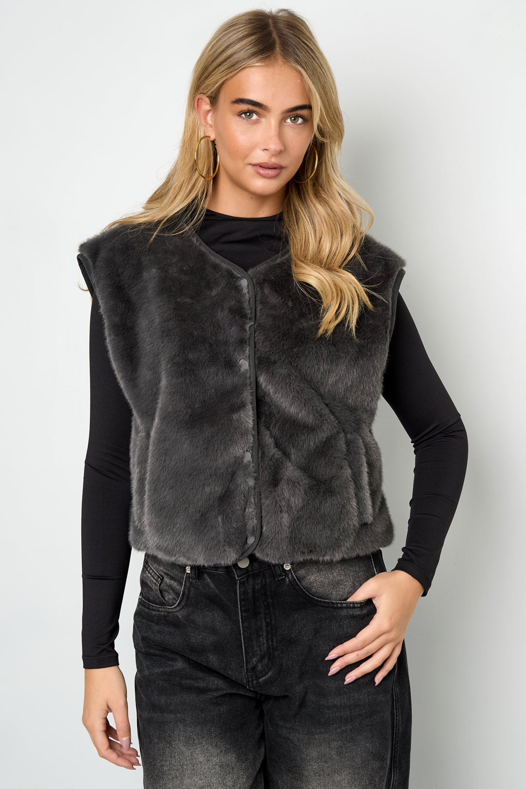 Black Rylee faux fur vest with a plush soft finish worn as part of a layered outfit from Sorea Fashion.